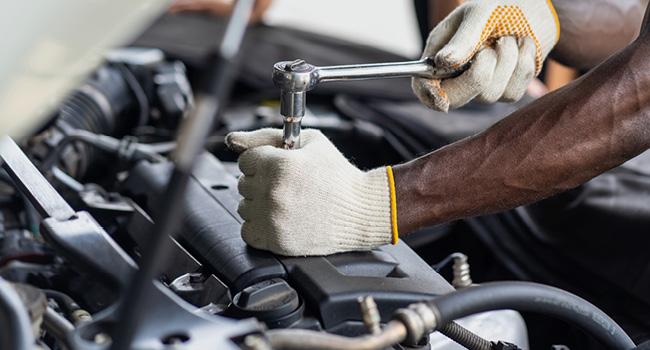 Mechanic hands working on an engine